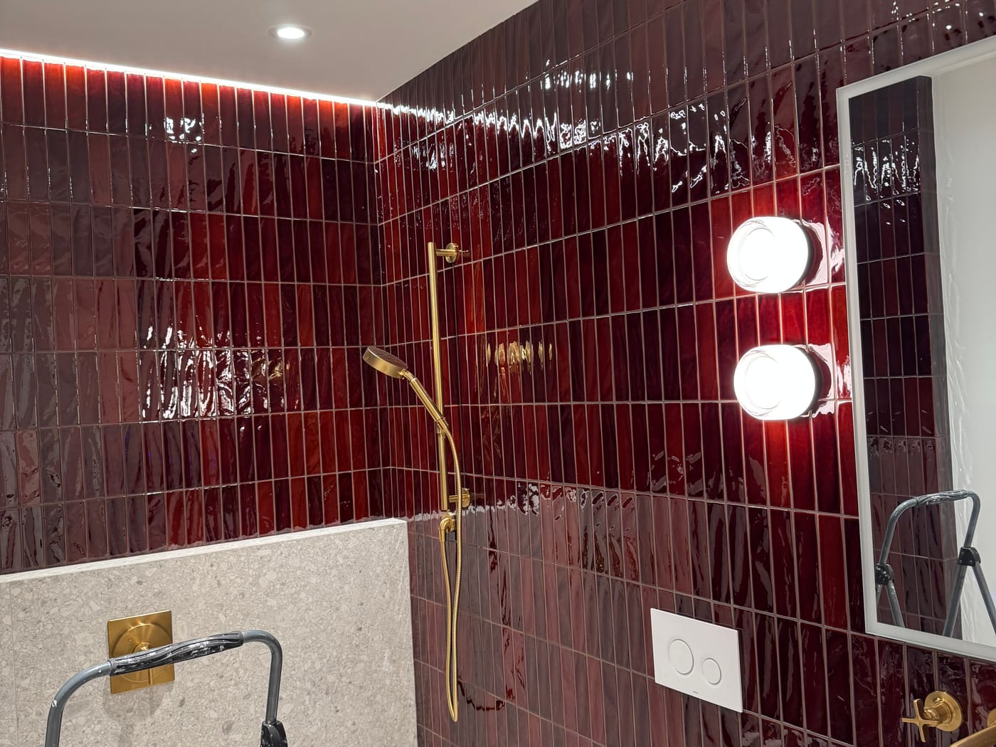 Bathroom with a tiled shower, lighting, and fixture wiring