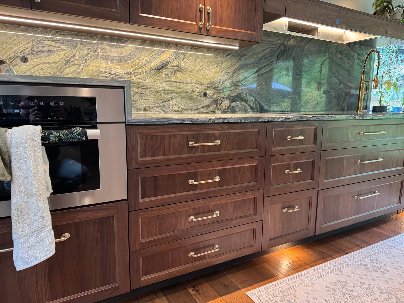 Remodeled kitchen with a full marble backsplash and under-cabinet LED lighting