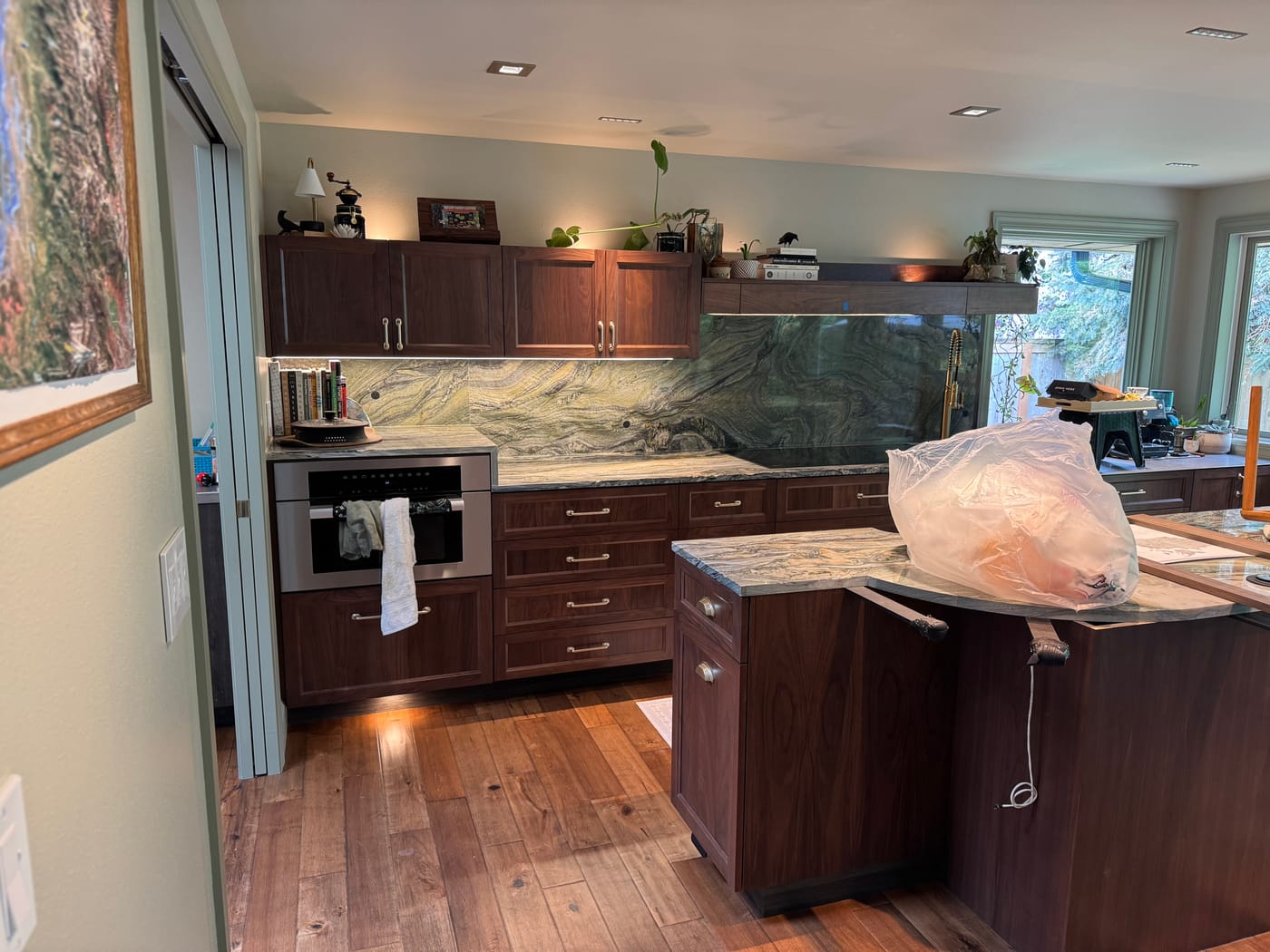 Custom kitchen with a marble waterfall island and under-cabinet lighting
